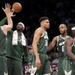 Milwaukee Bucks forward Giannis Antetokounmpo (34) celebrates with his teammates as they are substituted in the final minutes of the second half of an NBA basketball game against the Brooklyn Nets, Tuesday, Feb. 28, 2023, in New York. (AP Photo/John Minchillo)