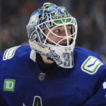 Vancouver Canucks goalie Arturs Silovs watches play after coming out of the net to play the puck during the second period of the team's NHL hockey game against the New York Rangers on Wednesday, Feb. 15, 2023, in Vancouver, British Columbia. (Darryl Dyck/The Canadian Press via AP)