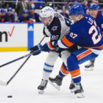 
              Winnipeg Jets' Pierre-Luc Dubois (80) fights for control of the puck with New York Islanders' Anders Lee (27) during the first period of an NHL hockey game Wednesday, Feb. 22, 2023, in Elmont, N.Y. (AP Photo/Frank Franklin II)
            