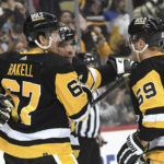 
              Pittsburgh Penguins center Sidney Crosby (87) celebrates with Rickard Rakell (67) and Jake Guentzel (59) after a goal against the Tampa Bay Lightning during the second period of an NHL hockey game, Sunday, Feb. 26, 2023, in Pittsburgh. (AP Photo/Philip G. Pavely)
            