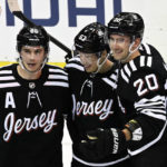 
              New Jersey Devils left wing Jesper Bratt (63) celebrates after his winning goal with Jack Hughes (86) and Michael McLeod (20) during the overtime period of an NHL hockey game against the Vancouver Canucks, Monday, Feb. 6, 2023, in Newark, N.J. (AP Photo/Bill Kostroun)
            