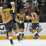 
              Vegas Golden Knights defenseman Shea Theodore, center, celebrates after scoring against theTampa Bay Lightning during the first period of an NHL hockey game Saturday, Feb. 18, 2023, in Las Vegas. (AP Photo/John Locher)
            