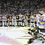
              Ukraine and Boston Junior Bruins peewee teams stand together during the national anthems before a hockey game, Saturday, Feb, 11, 2023, in Quebec City. (Jacques Boissinot/The Canadian Press via AP)
            