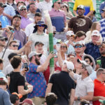 
              Fans on the 16th hole try to put together a cup snake during the final round of the Phoenix Open golf tournament, Sunday, Feb. 12, 2023, in Scottsdale, Ariz. (AP Photo/Darryl Webb)
            
