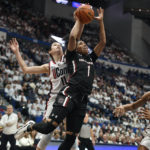 UConn's Lou Lopez-Senechal (11) blocks a shot by South Carolina's Zia Cooke (1) in the first half of an NCAA college basketball game, Sunday, Feb. 5, 2023, in Hartford, Conn. (AP Photo/Jessica Hill)