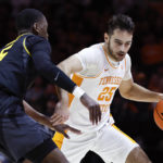 
              Tennessee guard Santiago Vescovi (25) drives as he is defended by Missouri guard D'Moi Hodge (5) during the first half of an NCAA college basketball game Saturday, Feb. 11, 2023, in Knoxville, Tenn. (AP Photo/Wade Payne)
            