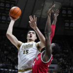 
              Purdue center Zach Edey (15) shoots over Ohio State center Felix Okpara (34) in the second half of an NCAA college basketball game in West Lafayette, Ind., Sunday, Feb. 19, 2023. Purdue defeated Ohio State 82-55. (AP Photo/Michael Conroy)
            