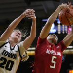 
              Iowa guard Kate Martin (20) fights for a rebound with Maryland guard Brinae Alexander (5) during the first half of an NCAA college basketball game, Thursday, Feb. 2, 2023, in Iowa City, Iowa. (AP Photo/Charlie Neibergall)
            