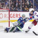 
              Vancouver Canucks goalie Arturs Silovs, left, stops New York Rangers' Artemi Panarin on a breakaway during the second period of an NHL hockey game Wednesday, Feb. 15, 2023, in Vancouver, British Columbia. (Darryl Dyck/The Canadian Press via AP)
            