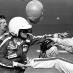 
              FILE - Bobby Allison, center, holds race driver Cale Yarborough's foot after Yarborough, right, kicked him following  the Daytona 500 auto race in Daytona Beach, Fla., Feb. 18, 1979.  (AP Photo/Ric Feld, File)
            