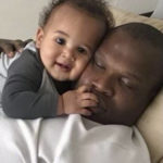 
              In this undated photo provided by Lindsay Myeni, Lindani Myeni holds his infant son, Nsizwa, as he sleeps. Myeni was fatally shot by Honolulu police in 2021 after he physically attacked officers, who responded when an upset occupant of a home complained a stranger had entered uninvited wearing a feathered headband and made bizarre comments. Results of studies of Myeni's brain tissue, obtained by The Associated Press, show the 29-year-old South African rugby player had Stage 3 CTE, or brain trauma caused by repeated concussions. (Lindsay Myeni via AP)
            