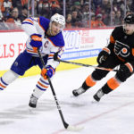 Edmonton Oilers' Connor McDavid, left, skates the puck past Philadelphia Flyers' Rasmus Ristolainen during the first period of an NHL hockey game Thursday, Feb. 9, 2023, in Philadelphia. (AP Photo/Derik Hamilton)