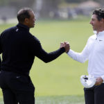 
              Tiger Woods, left, shakes hands with Rory McIlroy on the ninth green after they both finished the second round of the Genesis Invitational golf tournament at Riviera Country Club, Friday, Feb. 17, 2023, in the Pacific Palisades area of Los Angeles. (AP Photo/Ryan Kang)
            