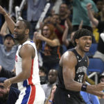 Orlando Magic center Wendell Carter Jr. (34) celebrates after scoring the game-winning basket as time expired while Detroit Pistons guard Alec Burks, left, looks for a ruling during the second half of an NBA basketball game, Thursday, Feb. 23, 2023, in Orlando, Fla. (AP Photo/Phelan M. Ebenhack)