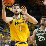 Michigan center Hunter Dickinson (1) attempts a layup as Michigan State forward Malik Hall (25) defends during the second half of an NCAA college basketball game, Saturday, Feb. 18, 2023, in Ann Arbor, Mich. (AP Photo/Carlos Osorio)