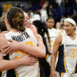 
              Marquette's Jordan King hugs Chloe Marotta after an NCAA college basketball game against UConn Wednesday, Feb. 8, 2023, in Milwaukee. (AP Photo/Aaron Gash)
            