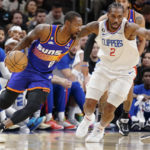 
              Phoenix Suns' Terrence Ross (8) drives around Los Angeles Clippers' Kawhi Leonard (2) during the first half of an NBA basketball game Thursday, Feb. 16, 2023, in Phoenix. (AP Photo/Darryl Webb)
            