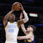 Los Angeles Lakers forward Rui Hachimura, left, shoots as Golden State Warriors guard Ty Jerome defends during the first half of an NBA basketball game Thursday, Feb. 23, 2023, in Los Angeles. (AP Photo/Mark J. Terrill)
