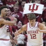 Indiana's Trayce Jackson-Davis, left, reacts with Miller Kopp (12) after Jackson-Davis hit a basket and was fouled during the first half of an NCAA college basketball game against Purdue, Saturday, Feb. 4, 2023, in Bloomington, Ind. (AP Photo/Darron Cummings)