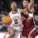
              South Carolina guard Meechie Johnson (5) drives against Alabama guard Mark Sears, right, during the second half of an NCAA college basketball game Wednesday, Feb. 22, 2023, in Columbia, S.C. Alabama won 78-76 in overtime. (AP Photo/Sean Rayford)
            