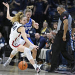 
              Creighton's Morgan Maly (30) fouls UConn's Dorka Juhasz (14) during the second half of an NCAA college basketball game Wednesday, Feb. 15, 2023, in Storrs, Conn. (AP Photo/Jessica Hill)
            