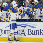 
              Buffalo Sabres center Dylan Cozens, foreground, is congratulated by teammates after scoring against the San Jose Sharks during the first period of an NHL hockey game in San Jose, Calif., Saturday, Feb. 18, 2023. (AP Photo/Jeff Chiu)
            