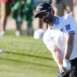 
              Adam Hadwin chips to the ninth green during the first round of the Phoenix Open golf tournament Thursday, Feb. 9, 2023, in Scottsdale, Ariz. Hadwin finished at five under par and is tied for the lead. (AP Photo/Darryl Webb)
            