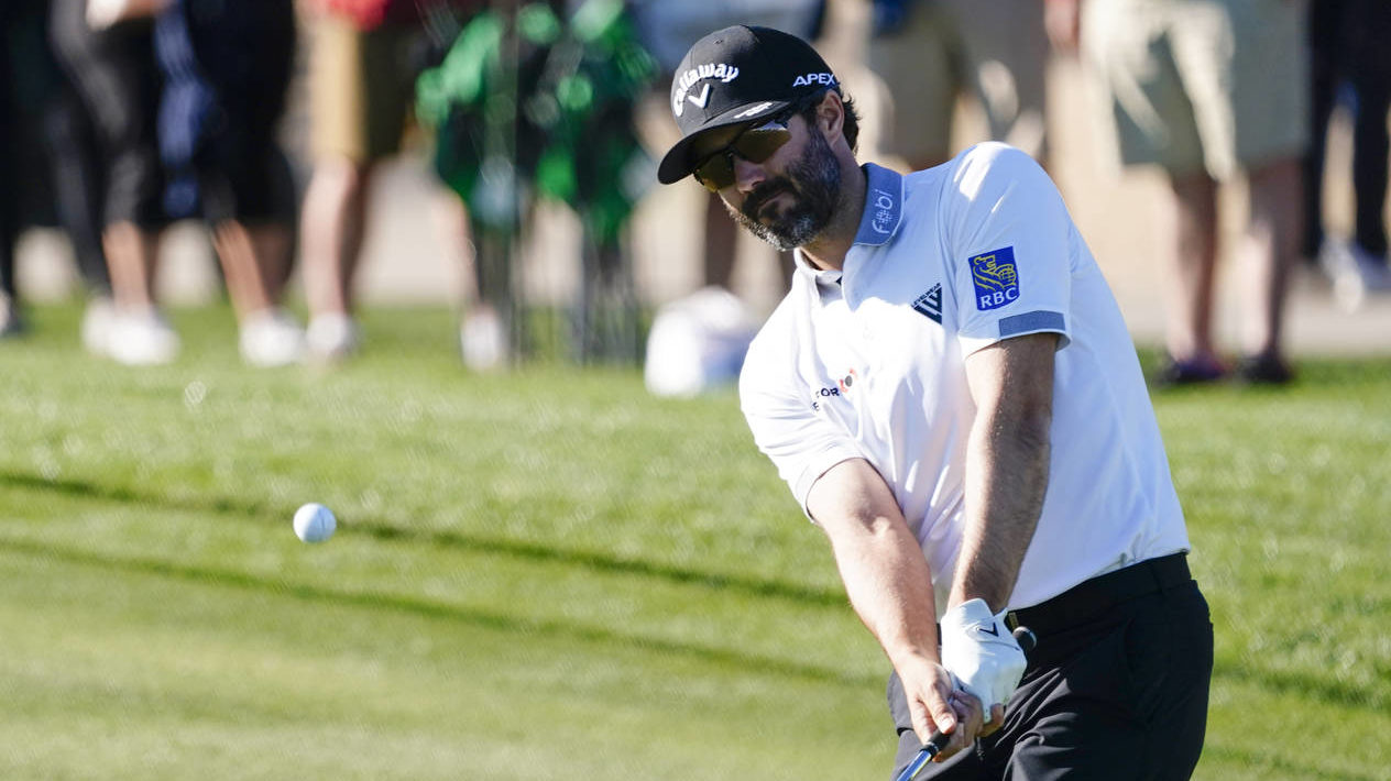 Adam Hadwin chips to the ninth green during the first round of the WM Phoenix Open golf tournament ...