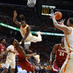 Tennessee guard Jahmai Mashack (15) collides with Alabama forward Nick Pringle (23) as he passes the ball to forward Uros Plavsic (33) during the first half of an NCAA college basketball game Wednesday, Feb. 15, 2023, in Knoxville, Tenn. (AP Photo/Wade Payne)
