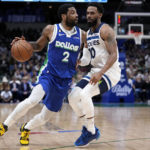 
              Dallas Mavericks guard Kyrie Irving (2) works against Minnesota Timberwolves' Mike Conley, right, in the second half of an NBA basketball game, Monday, Feb. 13, 2023, in Dallas. (AP Photo/Tony Gutierrez)
            