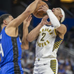 Orlando Magic guard Jalen Suggs, left, knocks the ball from Indiana Pacers guard Andrew Nembhard (2) during the first half of an NBA basketball game Saturday, Feb. 25, 2023, in Orlando, Fla. (AP Photo/Alan Youngblood)