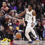 Toronto Raptors forward O.G. Anunoby (3) reaches for the ball in front of New Orleans Pelicans guard Josh Richardson (2) during the first half of an NBA basketball game Thursday, Feb. 23, 2023, in Toronto. (Frank Gunn/The Canadian Press via AP)