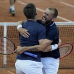 
              Dan Evans, right, and Neal Skupski, of Britain, celebrate after defeating Robert Farah and Juan Sebastian Cabal, of Colombia, at the end of their Davis Cup qualification doubles match in Cota, Colombia, Saturday, Feb. 4, 2023. (AP Photo/Fernando Vergara)
            