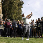 
              Tiger Woods hits his second shot from the rough on the 13th hole during the third round of the Genesis Invitational golf tournament at Riviera Country Club, Saturday, Feb. 18, 2023, in the Pacific Palisades area of Los Angeles. (AP Photo/Ryan Kang)
            