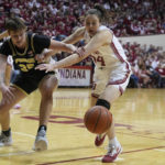 Purdue's Rickie Woltman (35) and Indiana's Mackenzie Holmes (54) battle for a loose ball during the first half of an NCAA college basketball game, Sunday, Feb. 19, 2023, in Bloomington, Ind. (AP Photo/Darron Cummings)