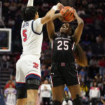
              South Carolina guard Raven Johnson (25) attempts to shoot over Mississippi forward Snudda Collins (5) during the second half of an NCAA college basketball game in Oxford, Miss., Sunday, Feb. 19, 2023. (AP Photo/Rogelio V. Solis)
            