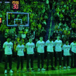 
              The Michigan State team stands during a moment of silence before the first half of an NCAA college basketball game against Michigan, Saturday, Feb. 18, 2023, in Ann Arbor, Mich. Michigan honored the victims of the MSU shooting that killed three and injured five Monday. (AP Photo/Carlos Osorio)
            