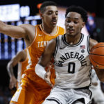 
              Vanderbilt guard Tyrin Lawrence (0) works against Tennessee guard Tyreke Key during the second half of an NCAA college basketball game Wednesday, Feb. 8, 2023, in Nashville, Tenn. (AP Photo/Wade Payne)
            