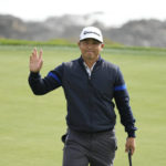 Kurt Kitayama waves after making a birdie putt on the eighth green of the Pebble Beach Golf Links during the second round of the AT&T Pebble Beach Pro-Am golf tournament in Pebble Beach, Calif., Friday, Feb. 3, 2023. (AP Photo/Eric Risberg)