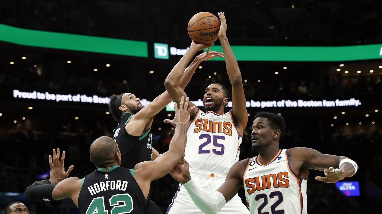 Phoenix Suns' Mikal Bridges (25) shoots against Boston Celtics' Derrick White, top left, and Al Hor...