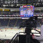 
              A camera person records a game between Switzerland's Romande Chouettes and Durham, N.C.'s West Lightning during a girls hockey game at the International Peewee Tournament at Quebec City’s Videotron Centre on Friday, Feb 10, 2023.  A team of 11- and 12-year-old Ukrainian boys has been offered a respite from the war raging back home in having spent the past week in Quebec City preparing to compete in the International Peewee Tournament. Their much anticipated first game, against the Boston Junior Bruins, will be on Saturday. (AP Photo/John Wawrow)
            