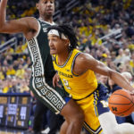 
              Michigan guard Kobe Bufkin (2) is defended by Michigan State guard A.J. Hoggard (11) during the second half of an NCAA college basketball game, Saturday, Feb. 18, 2023, in Ann Arbor, Mich. (AP Photo/Carlos Osorio)
            