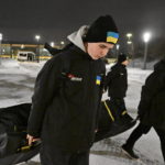 FILE -  Ukrainian peewee hockey players carry their gear to the arena as they arrive, Wednesday, Feb. 1, 2023 at the Videotron Centre in Quebec City. The Ukraine team will compete at the Quebec international peewee hockey tournament. (Jacques Boissinot/The Canadian Press via AP, File)