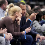Minnesota Timberwolves minority owner Alex Rodriguez, center right, talks with girlfriend Jac Cordeiro, center left, as they watch play in the first half of an NBA basketball game against the Dallas Mavericks, Monday, Feb. 13, 2023, in Dallas. (AP Photo/Tony Gutierrez)