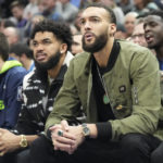 Minnesota Timberwolves' center Karl-Anthony Towns, left, and center Rudy Gobert, right, sit on the bench during the first half of an NBA basketball game against the Utah Jazz Wednesday, Feb. 8, 2023, in Salt Lake City. (AP Photo/Rick Bowmer)