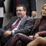 FILE - Washington Redskins owner Dan Snyder, left, and his wife Tanya Snyder, listen to head coach Ron Rivera during a news conference at the team's NFL football training facility in Ashburn, Va., Thursday, Jan. 2, 2020. The Washington Commanders are denying the contents of a report about the team's sale process and demands being made by owner Dan Snyder. The team in a statement late Monday, Feb. 27, 2023, said a story published hours earlier by The Washington Post is "simply untrue." (AP Photo/Alex Brandon, File)