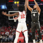 
              Providence guard Jared Bynum (4) over  St. John's guard Kolby King (12) during the first half of an NCAA college basketball game, Saturday, Feb. 11, 2023 in New York. (AP Photo/Bryan Woolston)
            