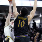 Northwestern forward Tydus Verhoeven (10) blocks a shot by Purdue guard Fletcher Loyer (2) during the first half of an NCAA college basketball game in Evanston, Ill., Sunday, Feb. 12, 2023. (AP Photo/Nam Y. Huh)