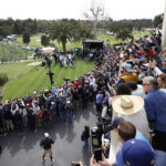 
              The gallery watches Tiger Woods, bottom left, as hits from the first tee during the first round of the Genesis Invitational golf tournament at Riviera Country Club, Thursday, Feb. 16, 2023, in the Pacific Palisades area of Los Angeles. (AP Photo/Ryan Kang)
            