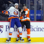 New York Islanders' Adam Pelech, left, and Philadelphia Flyers' Noah Cates collide during the second period of an NHL hockey game, Monday, Feb. 6, 2023, in Philadelphia. (AP Photo/Matt Slocum)